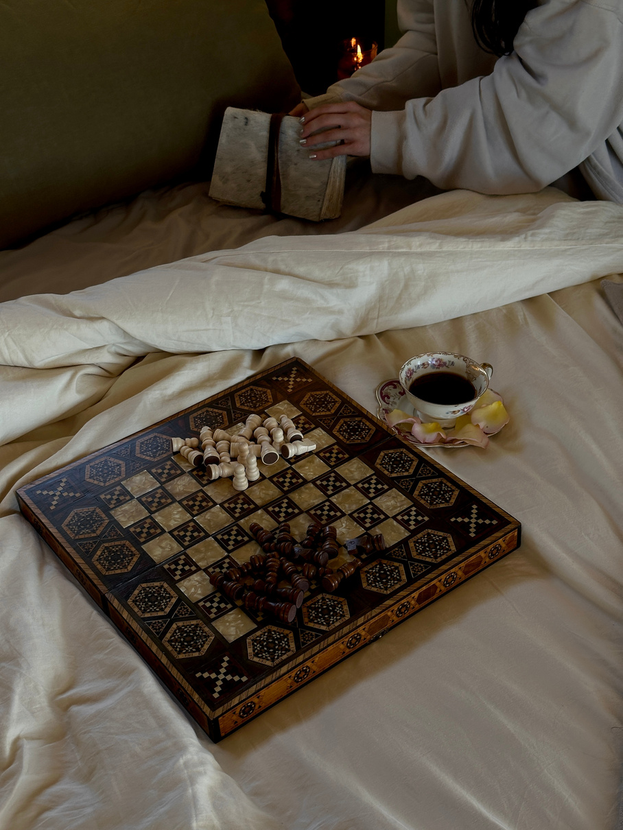 Morning coffee and board game in bed