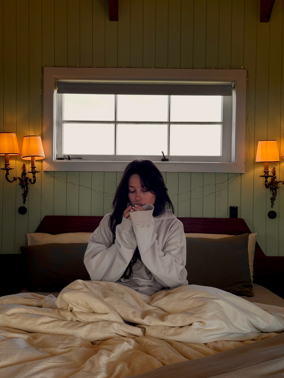 Creator relaxing in a boutique hotel bed
